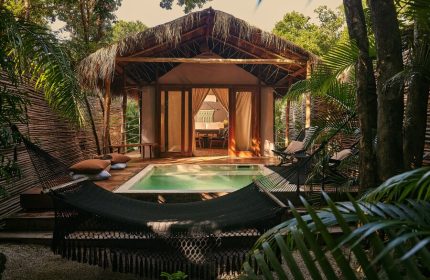 Our Habitas Tulum gay-friendly hotel room with pool, hammock, and thatched roof. A relaxing retreat for gay travelers in Tulum, Mexico.