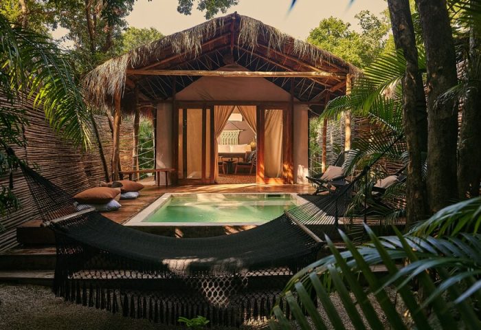 Our Habitas Tulum gay-friendly hotel room with pool, hammock, and thatched roof. A relaxing retreat for gay travelers in Tulum, Mexico.