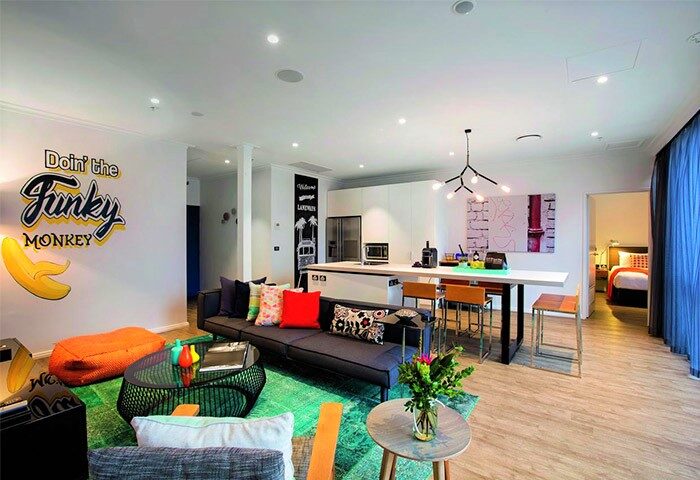 Ovolo Laneways pet-friendly hotel suite. Funky decor, modern kitchen, and living area. A gay-friendly hotel with unique design elements.