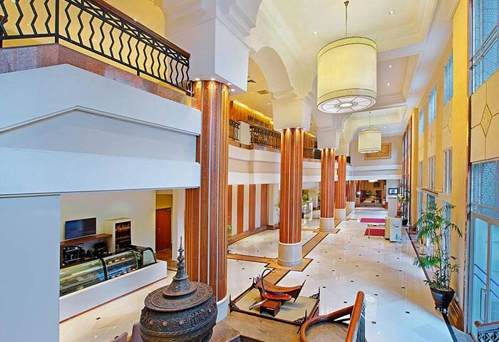 PARKROYAL Yangon Hotel's grand lobby. This gay-friendly hotel features soaring ceilings, marble floors, and elegant decor, perfect for gay travelers.
