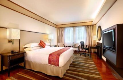 PARKROYAL Yangon Hotel room. Gay-friendly hotel with king bed, desk, TV, and seating area. Comfortable stay in Yangon, Myanmar.