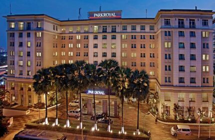 PARKROYAL Yangon Hotel exterior. Gay-friendly hotel in Yangon, Myanmar. The facade of the hotel, with palm trees in front of the entrance.