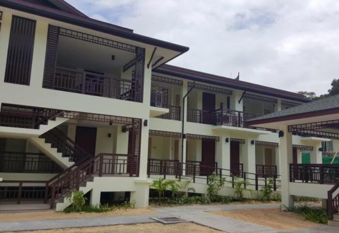 PP Princess Resort exterior. Gay-friendly hotel architecture with balconies, stairs, and tropical plants. Ideal for gay men travel.
