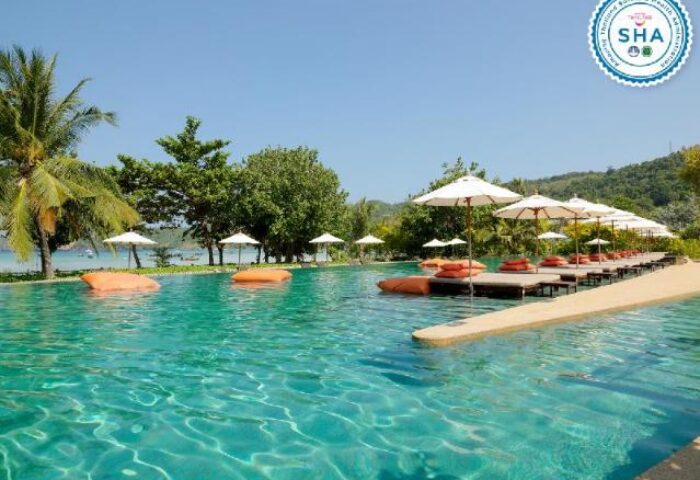 PP Princess Resort pool view. Gay-friendly hotel with sunbeds, umbrellas, and turquoise water. A great destination for gay men travelers.