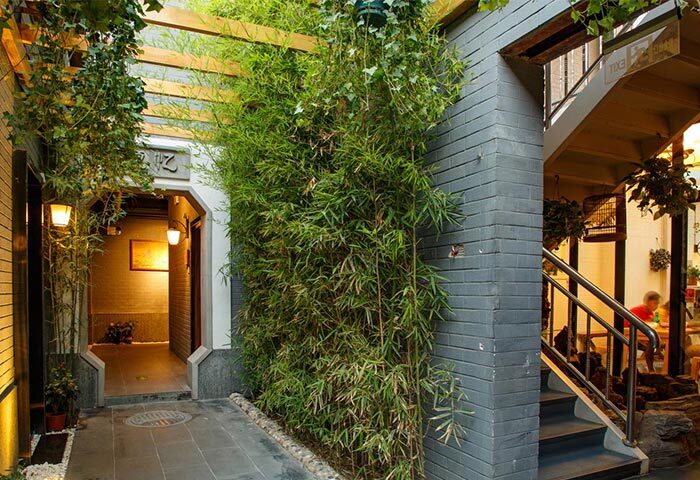 PUREMIND Hutong Courtyard Hotel's exterior. Gay-friendly hotel with bamboo, brickwork, and a courtyard entrance. Ideal for gay travel.