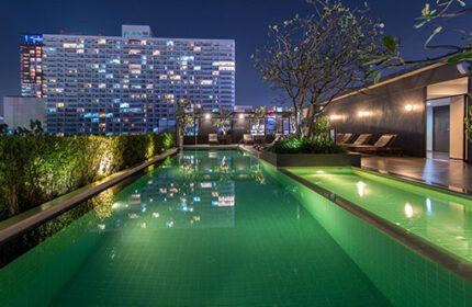 Page 10 Hotel rooftop pool at night. Gay-friendly hotel with city views. Relaxing travel destination for gay men. Modern design, luxury.