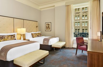 Gay-Friendly Palace Hotel, a Luxury Collection Hotel, San Francisco room. Two beds, desk, chair, and view. Hotel room interior.
