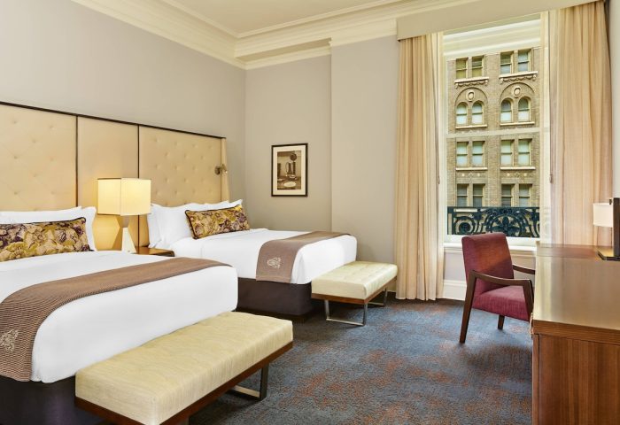 Gay-Friendly Palace Hotel, a Luxury Collection Hotel, San Francisco room. Two beds, desk, chair, and view. Hotel room interior.