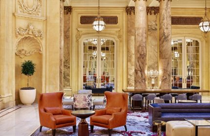 Lobby interior at Palace Hotel, a Luxury Collection Hotel, San Francisco. Gay-friendly hotel with marble columns and elegant seating.