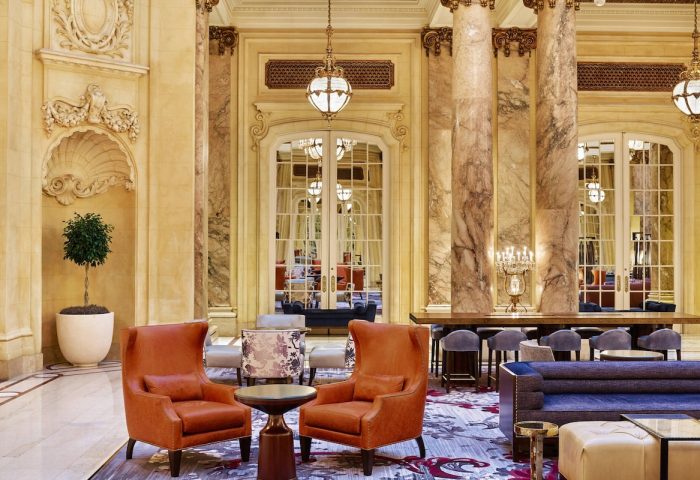 Lobby interior at Palace Hotel, a Luxury Collection Hotel, San Francisco. Gay-friendly hotel with marble columns and elegant seating.