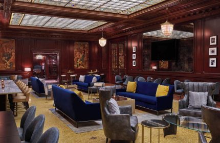 Lounge at Palace Hotel, a Luxury Collection Hotel, San Francisco. Gay-Friendly Hotel's interior with plush seating, rich wood, and stained glass ceiling.