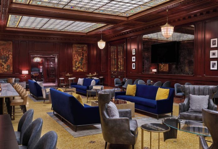Lounge at Palace Hotel, a Luxury Collection Hotel, San Francisco. Gay-Friendly Hotel's interior with plush seating, rich wood, and stained glass ceiling.