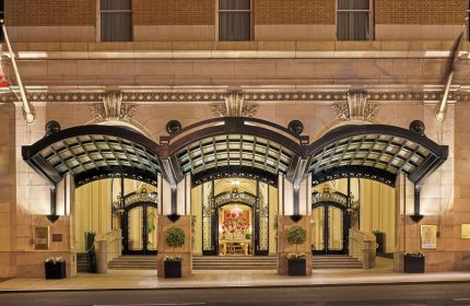 Palace Hotel, a Luxury Collection Hotel, San Francisco entrance. Gay-friendly hotel with ornate doors and glass canopies at night.
