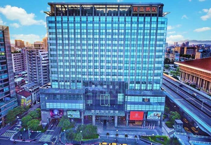 Palais de Chine Hotel: A gay-friendly hotel in Taipei, Taiwan. Modern architecture with blue glass facade. Urban setting, travel destination.