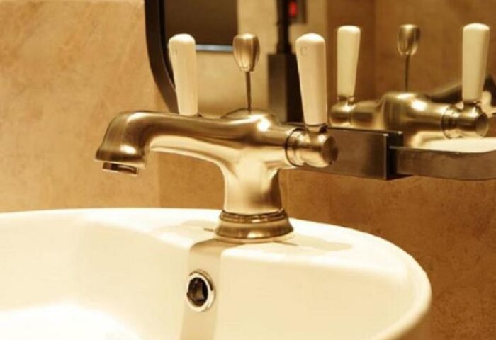 Palais de Chine Hotel bathroom sink. Gay-friendly hotel with premium fixtures. Upscale travel for gay men. Hotel sink with white handles.