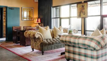 Palihotel Melrose's gay-friendly interior. A stylish seating area with patterned sofas, vintage rugs, and natural light. A great choice for gay travel.