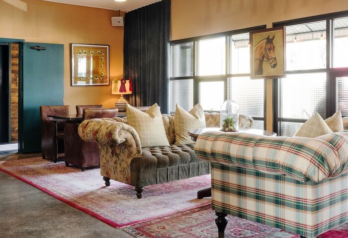 Palihotel Melrose's gay-friendly interior. A stylish seating area with patterned sofas, vintage rugs, and natural light. A great choice for gay travel.