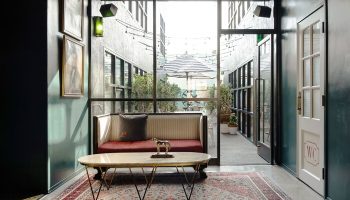 Palihotel Melrose lobby with seating area. Gay-friendly hotel with stylish interior design, courtyard view, and vintage rug. Great for gay travel.