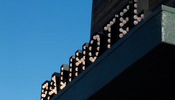Palihotel Melrose sign. Gay-friendly hotel in Melrose, Los Angeles. The hotel's name is spelled out with illuminated bulbs against a bright blue sky.