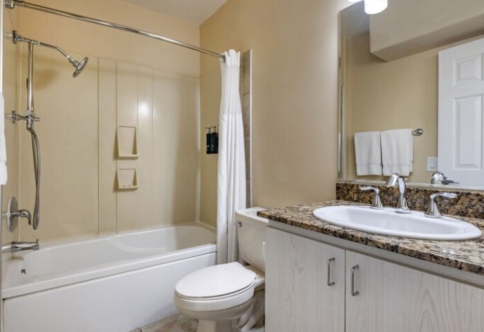 Bathroom at Gay-Friendly Hilton Vacation Club Palm Canyon Resort in Palm Springs. Bathtub, shower, sink, and toilet. Perfect for gay travel.