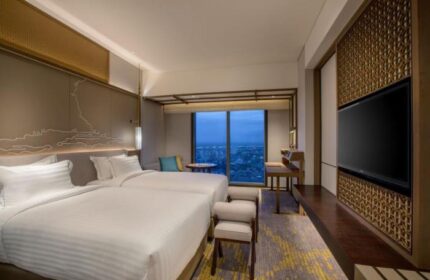 Pan Pacific Yangon, gay-friendly hotel. Deluxe room with two beds, city view, desk, and TV. Upscale travel for gay men in Yangon, Myanmar.