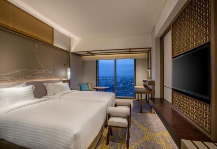 Pan Pacific Yangon, gay-friendly hotel. Deluxe room with two beds, city view, desk, and TV. Upscale travel for gay men in Yangon, Myanmar.