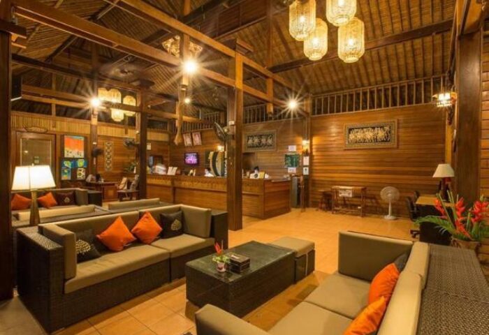 Lobby at Panviman Resort Koh Phangan, a gay-friendly hotel. Features wood decor, comfortable seating, and a relaxing atmosphere. Thailand travel.