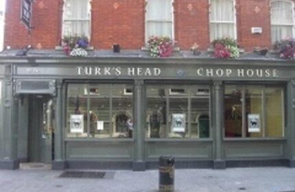 Turk's Head Chop House near Paramount Hotel, a gay-friendly hotel. The building's facade features windows and flower boxes. Dublin's nightlife.