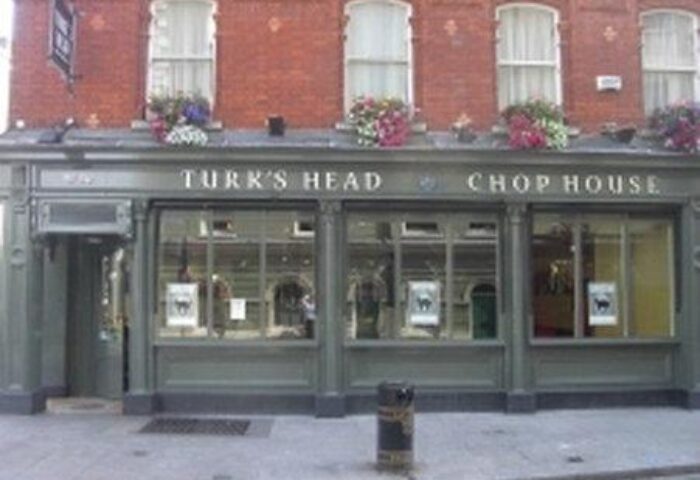 Turk's Head Chop House near Paramount Hotel, a gay-friendly hotel. The building's facade features windows and flower boxes. Dublin's nightlife.