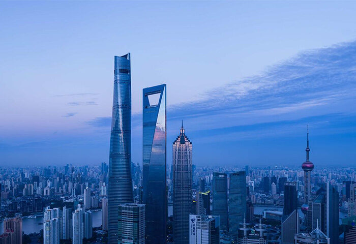 Shanghai's skyline at dusk, featuring the iconic Oriental Pearl Tower. Gay-friendly hotel Park Hyatt Shanghai offers stunning views.