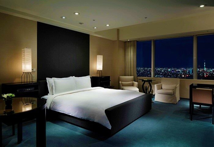 Park Hyatt Tokyo, a gay-friendly, pet-friendly hotel. Bedroom with city view at night. Luxury travel for gay men in Tokyo, Japan.