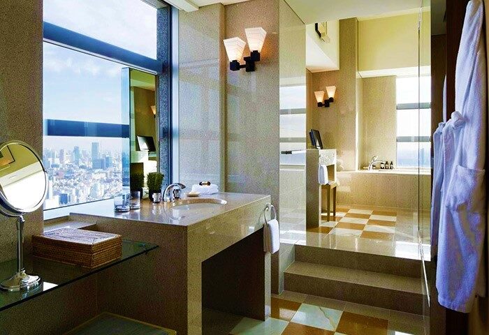 Park Hyatt Tokyo pet-friendly hotel bathroom. Modern design, city view, natural light. Gay-friendly hotel for discerning travelers.