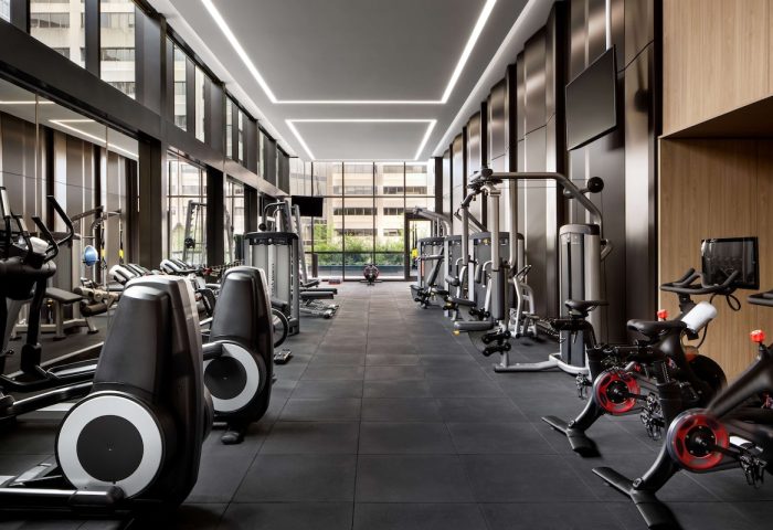Park Hyatt Toronto's gym. This gay-friendly hotel features modern exercise equipment, floor-to-ceiling windows, and sleek design.