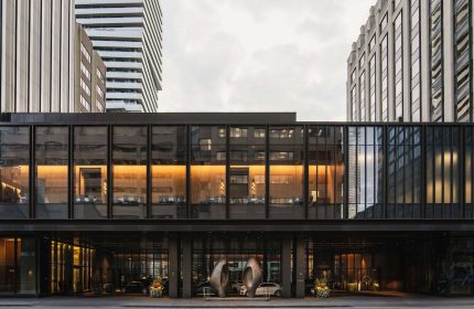 Park Hyatt Toronto, a gay-friendly hotel. Exterior view of the modern building's entrance, showing its sleek design and upscale ambiance.