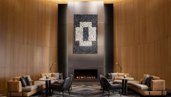 Park Hyatt Toronto's stylish lounge with a fireplace. A gay-friendly hotel offering luxury accommodations and a welcoming atmosphere.