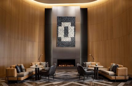 Park Hyatt Toronto's stylish lounge with a fireplace. A gay-friendly hotel offering luxury accommodations and a welcoming atmosphere.