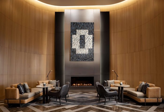 Park Hyatt Toronto's stylish lounge with a fireplace. A gay-friendly hotel offering luxury accommodations and a welcoming atmosphere.