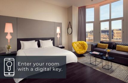 Park Plaza Victoria Amsterdam Hotel room. A gay-friendly hotel with digital key access, bed, sofa, and city view.