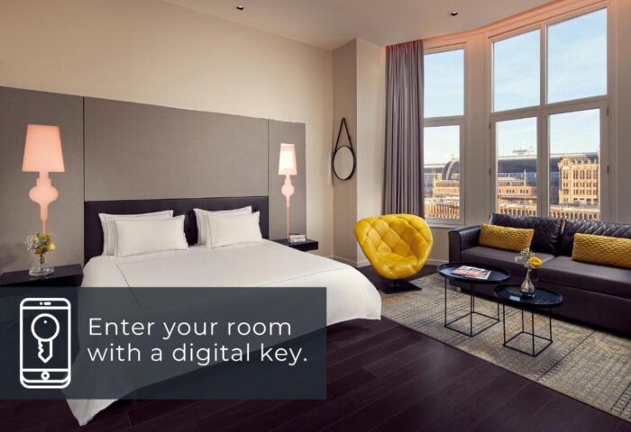 Park Plaza Victoria Amsterdam Hotel room. A gay-friendly hotel with digital key access, bed, sofa, and city view.