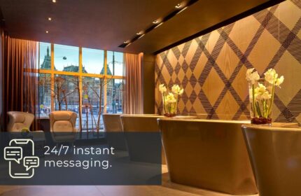 Park Plaza Victoria Amsterdam Hotel lobby. Gay-friendly hotel with modern design, reception desk, and city view. Perfect for gay men travelers.