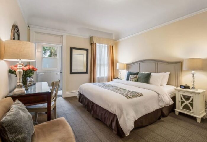 Parker Guest House room. Gay-friendly hotel bedroom with bed, desk, balcony, and nightstand. Comfortable stay for gay men travelers.
