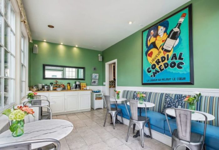 Parker Guest House dining area. Gay-friendly hotel with breakfast bar, seating, and vibrant art. A welcoming space for gay men travelers.