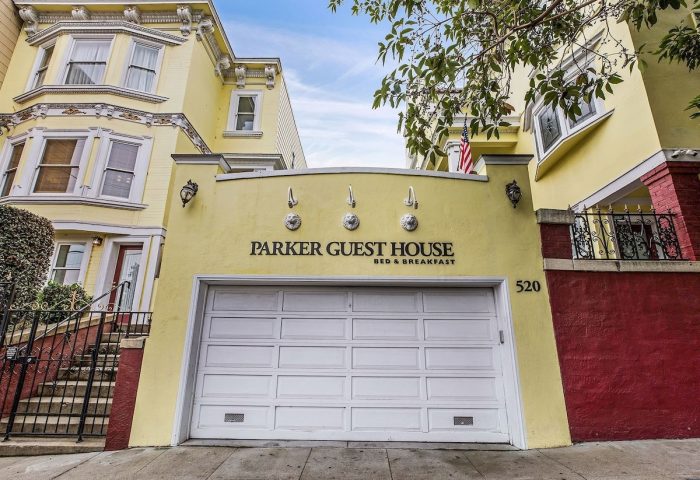 Parker Guest House, a gay-friendly hotel in San Francisco. Yellow building with garage door. Ideal lodging for gay men's travel.