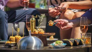 Parker Hotel Vancouver: Guests enjoy cocktails and appetizers. Gay-friendly hotel with luxury dining for gay men's travel.
