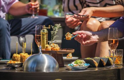 Parker Hotel Vancouver: Guests enjoy cocktails and appetizers. Gay-friendly hotel with luxury dining for gay men's travel.