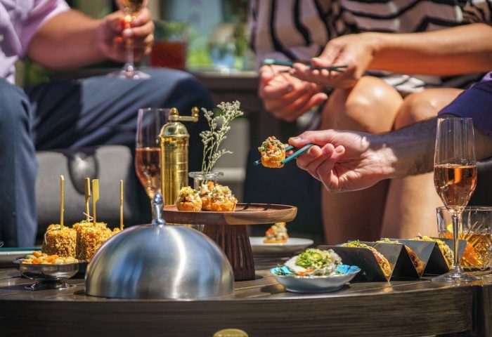 Parker Hotel Vancouver: Guests enjoy cocktails and appetizers. Gay-friendly hotel with luxury dining for gay men's travel.