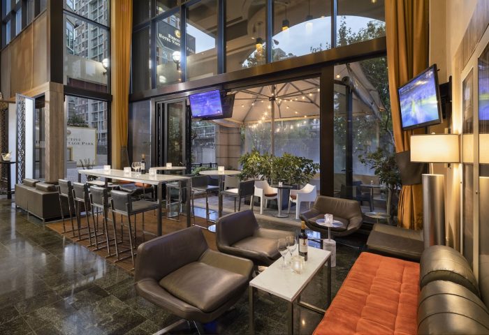 Parker Hotel Vancouver's gay-friendly lounge area with modern seating, tables, and outdoor patio. A great spot for gay men to relax.