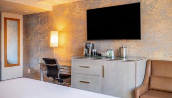 Parker Hotel Vancouver guest room. Desk, chair, TV, and coffee maker. Gay-friendly hotel with modern amenities for comfortable travel.
