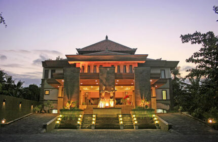 Pelangi Bali Hotel & Spa entrance at dusk. Gay-friendly hotel with traditional Balinese architecture and statues. Great for gay travel in Bali.
