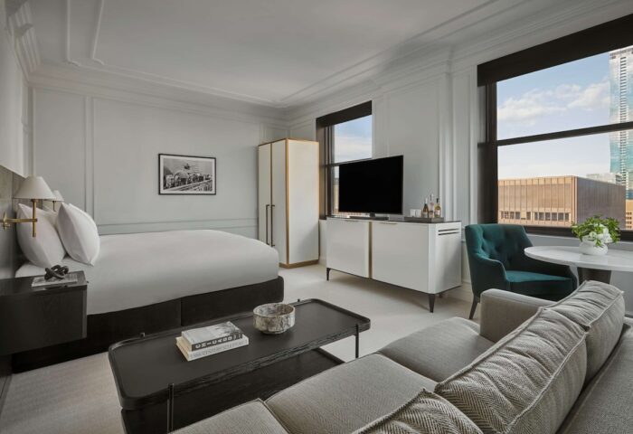 Pendry Chicago gay-friendly hotel room. Modern design with a bed, sofa, and city views. Upscale lodging for gay travelers in Chicago.